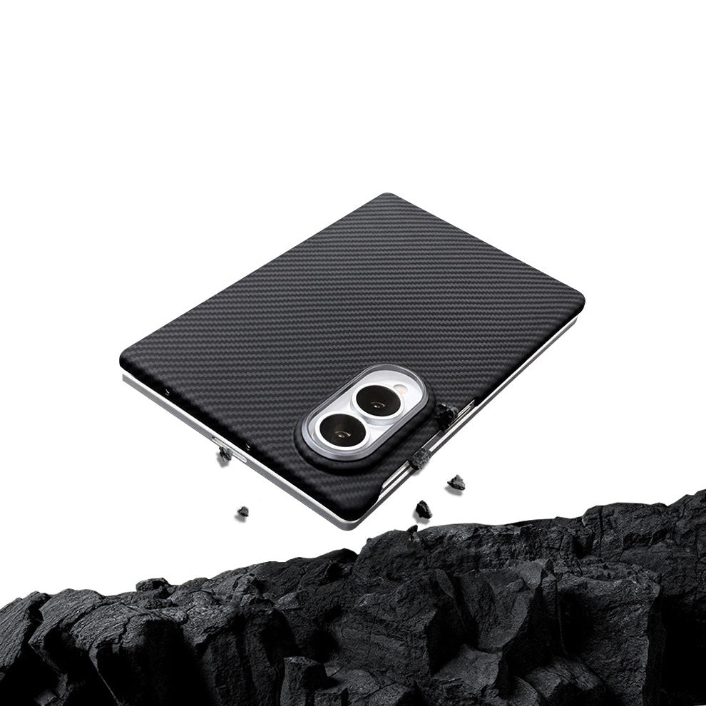 A folded phone in a black case rests at an angle above dark, jagged rocks against a white background.