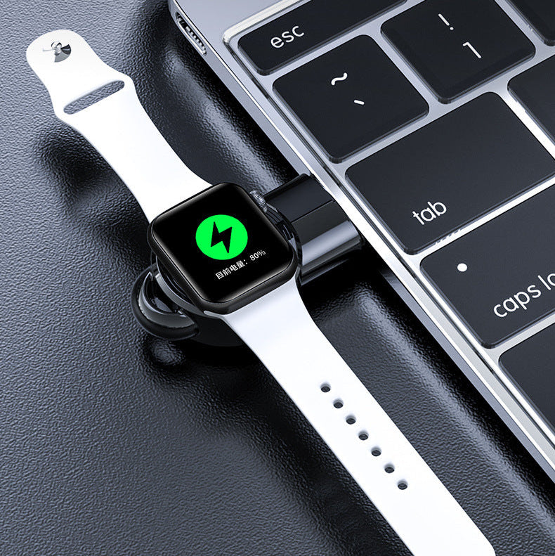 Smartwatch charging on a laptop keyboard with text about charging time.