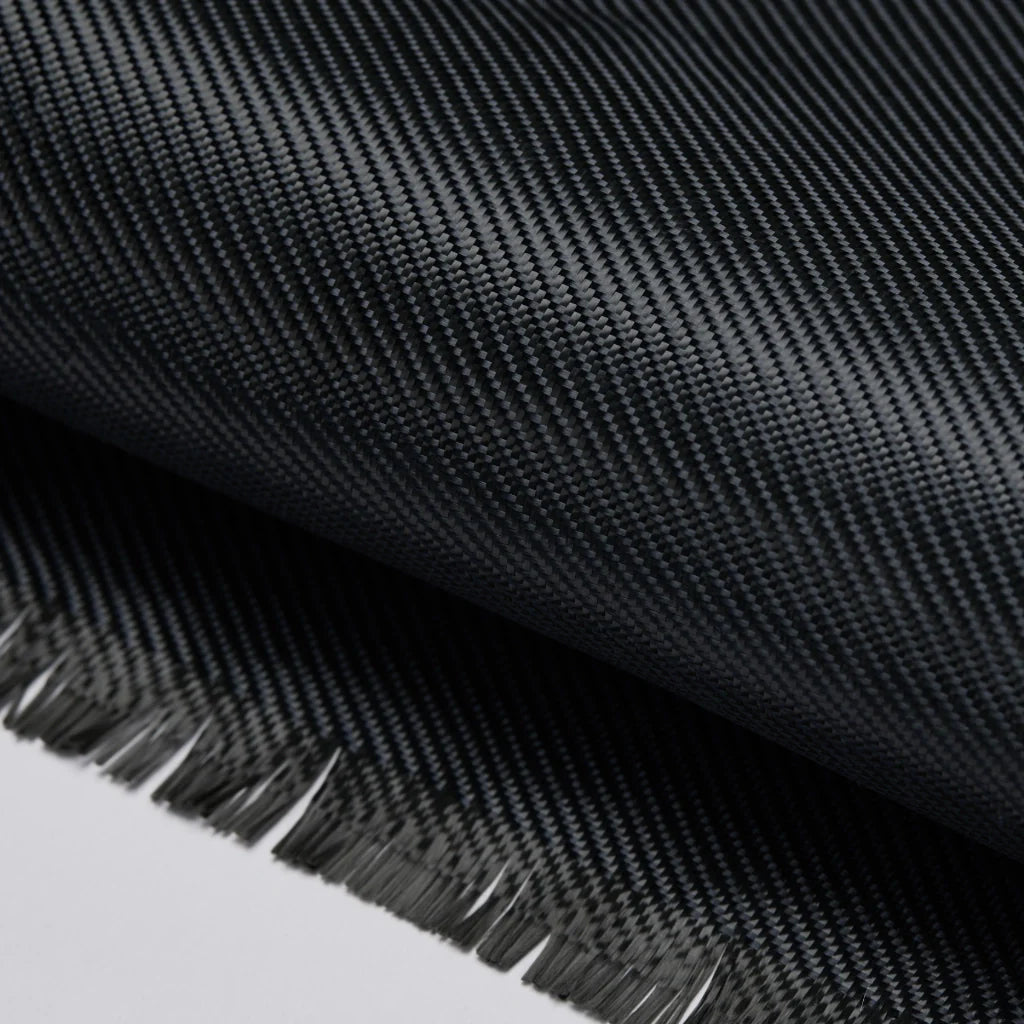 Macro shot of the raw black fabric material showing the tight weave and frayed edges of the fibers.